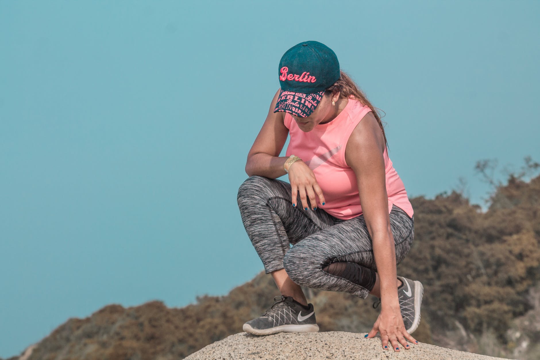 woman sitting on rock